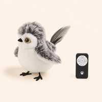 Pájaro Nieve de PawsAddict junto a su mando a distancia